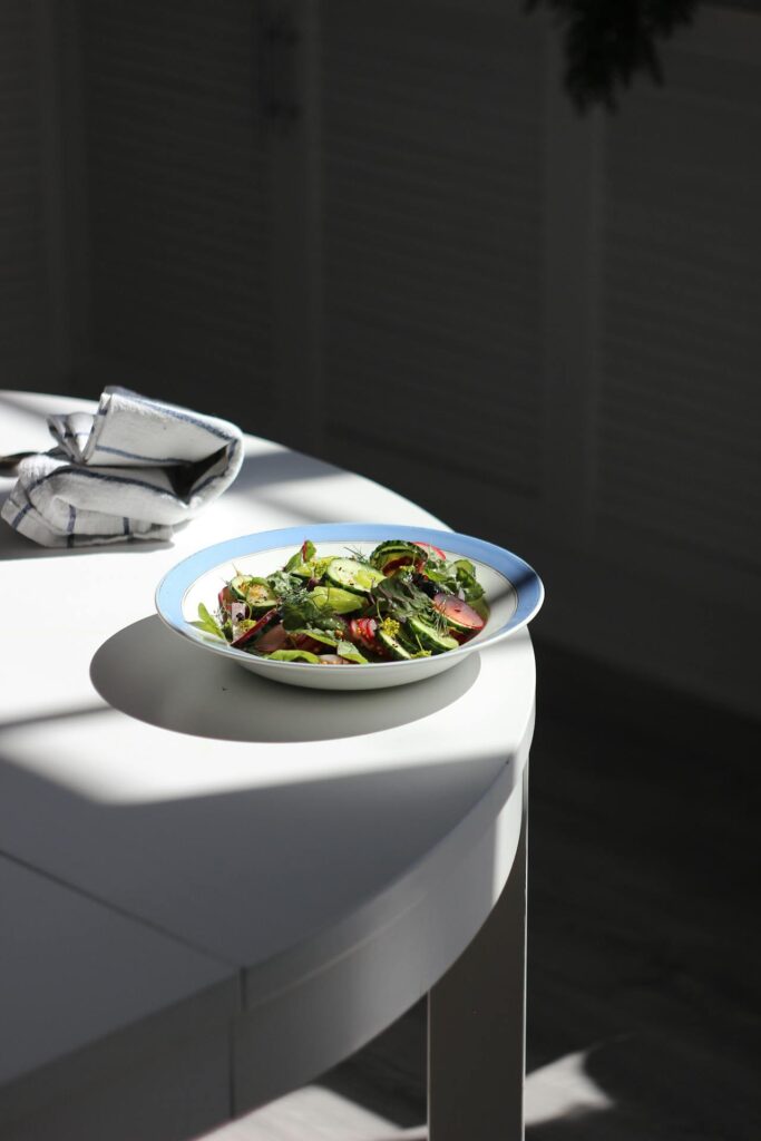 A bowl of green salad on the table